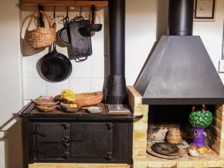 View of a firewood iron stove, a fireplace and some kitchen utensils in a farm house near the colonial town of Villa de Leyva, in central Colombia.の写真素材