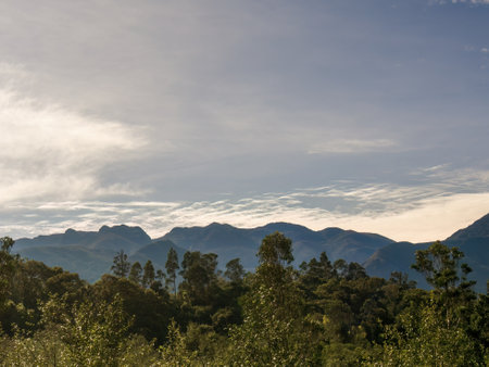 A formation of little soft clouds suspended over the east Andean mountains of central Colombia, in a sunny morning near the town of Arcabuco.の写真素材