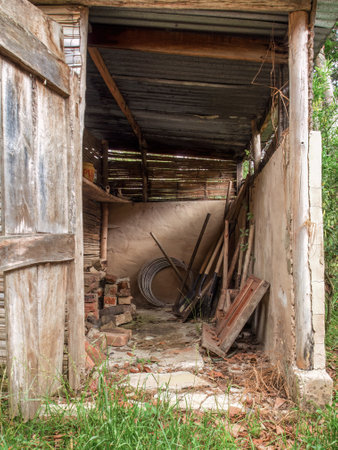 View of the tools and assorted objects in a rustic and very deteriorated small shed in a farm near the colonial town of Villa de Leyva in central Colombia.の写真素材
