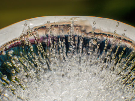 Extreme macro photography of the internal structure and air bubbles of an ice ball, illuminated by the morning sun in a garden in the eastern Andes of central Colombia.の写真素材
