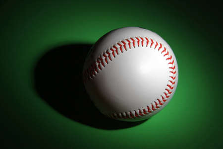Macro shot of a baseball's over green backgroundの写真素材