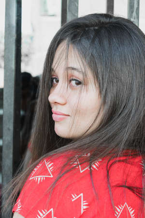 Beautiful Latin girl in a black windowの写真素材