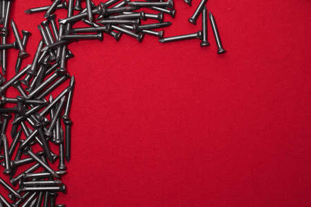 Template for advertising poster, made with steel nails on a red background, leaving space for text,...