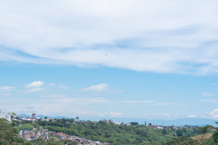 panoramic view of the horizon in the city of Pereira-Colombia, with urban and rural areas meeting, cloudy sky and warm climateの写真素材