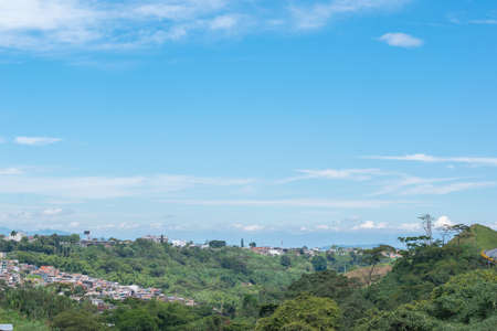 panoramic view of the horizon in the city of Pereira-Colombia, with urban and rural areas meeting, cloudy sky and warm climateの写真素材