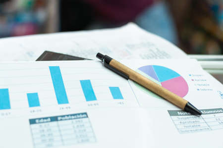 eco-friendly cardboard pencil. on top of a sales chart, abandoned due to poor financial status. declining balance sheet. concept of financial failureの写真素材