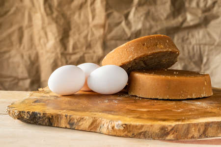bodegon of colombian panela and eggs, placed on a wooden board of Matarraton (Gliricidia sepium), ready for sale or human consumption. ingredients for typical food. food concept.の写真素材