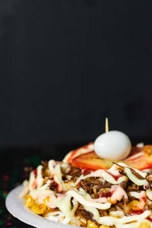 detail shot of a typical colombian street food dish, arepa with chicken and shredded beef with corn,...