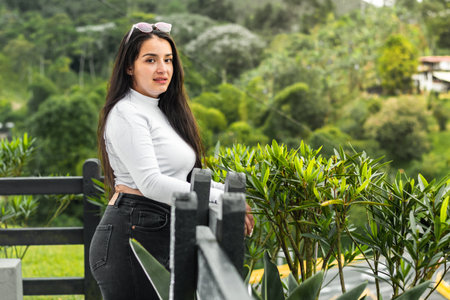 portrait of latina teenager in an outdoor park, taking a walk in the parkの写真素材