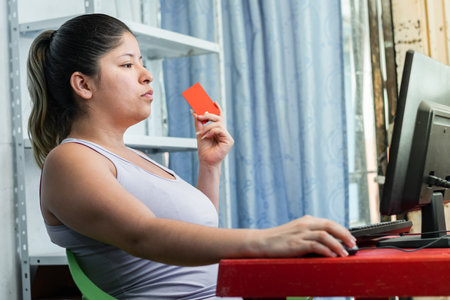 young woman with a credit card in her hand ready to make purchases onlineの写真素材