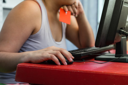 close-up of a latina girl's hand, using the computer to shop online.