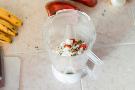 detailed view of a blender beaker with chopped vegetables in it