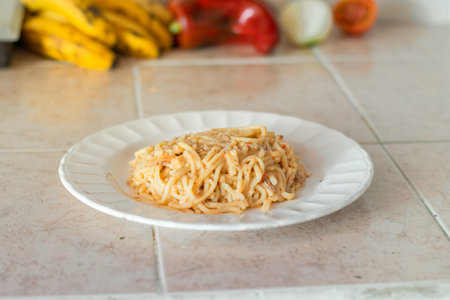 portion of spaghetti with stew served on a white plateの写真素材
