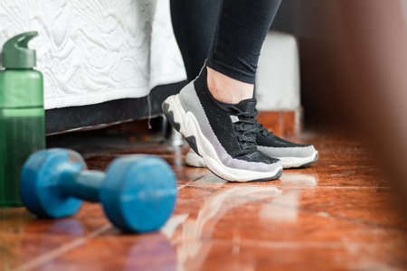 detailed view of the feet of a young latina woman stretching her feet before exercise