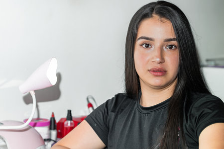 portrait of beautiful young latin woman looking straight ahead after putting on makeupの写真素材