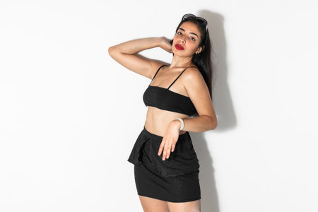 portrait of beautiful brown-skinned latina woman posing and looking straight ahead, on a white backgroundの写真素材