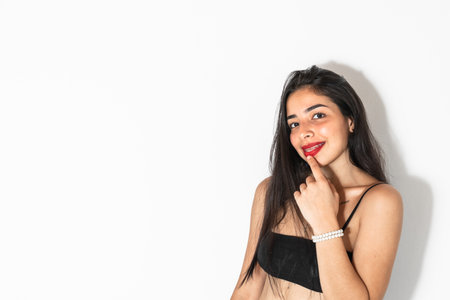 close-up portrait of a beautiful latin teenage girl smiling on a white backgroundの写真素材