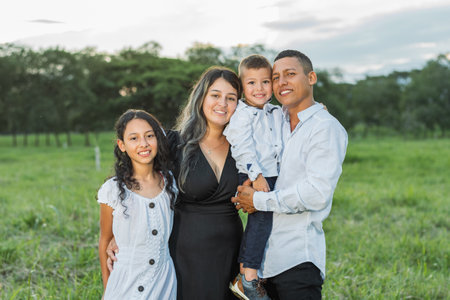 Latin family, together posing happily smiling as they stroll through the countryside.
