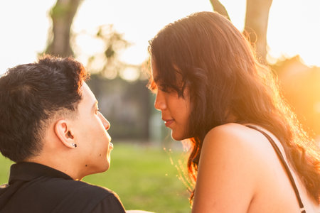 close-up of the profile of the faces of two young Latinos staring into each other's eyesの写真素材