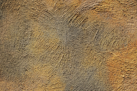Texture of coarse plaster of yellow and gray colors on the wallの写真素材