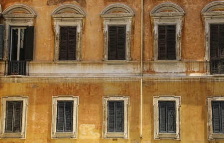 Traditional Italian windows with shutters in one of the houses of Rome, Italyの写真素材