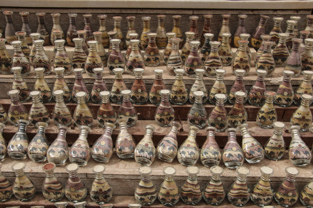 Traditional local souvenirs in Jordan. Bottles with colorful sand from the desert and the outlines of camelsの写真素材
