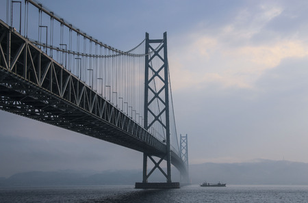 KOBE, JAPAN- MARCH 30, 2019: Akashi Kaikyo Bridge spanning the Seto Inland Sea from Awaji Island to Kobe, Japan.のeditorial素材