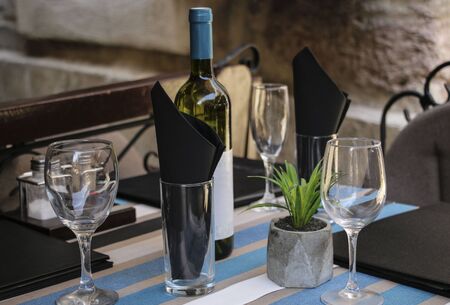 Served table in a summer cafe on a street in the old part of the tower Kotor, Montenegro.
