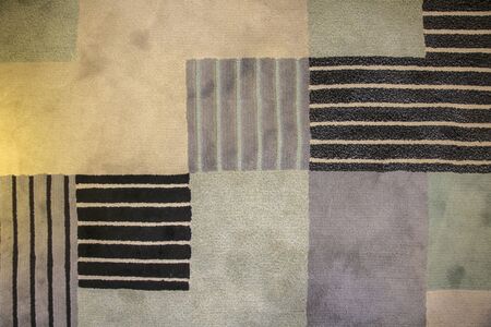 Texture of textile rug with pattern of beige, gray and black colors