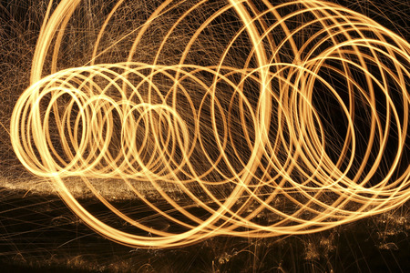 rings of fire and bright sparks light up the nightの写真素材