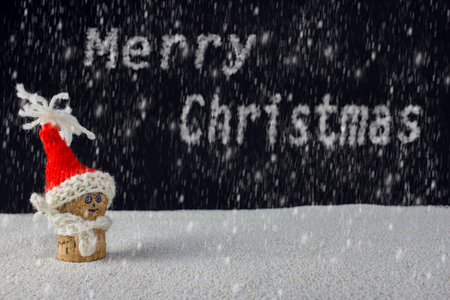 puppets with Christmas-hats and snow falling from the skyの写真素材