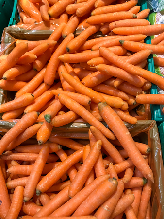 Basket with group of fresh and genuine carrots