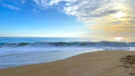 the view of the beach in the orange sunset at different timesの写真素材