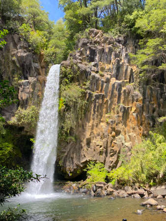 the white waterfall falling from the top of a rock wallの写真素材