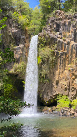 the white waterfall falling from the top of a rock wallの写真素材