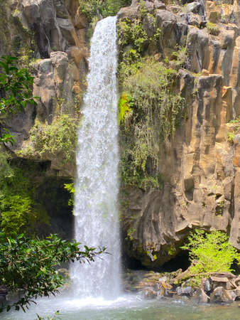 the white waterfall falling from the top of a rock wallの写真素材