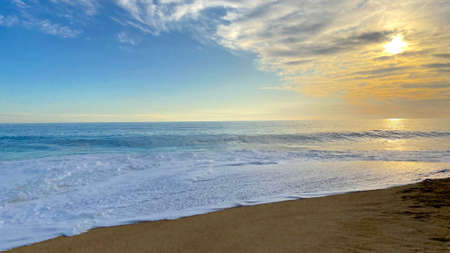 the view of the beautiful beach at sunsetの写真素材