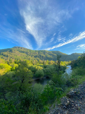 the view of the river from the green valley in the mountainsの写真素材