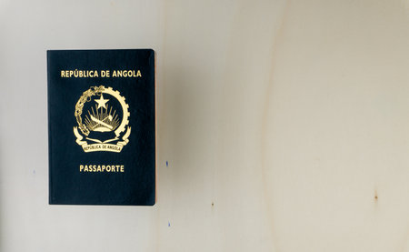 An overhead shot of Angolan passport isolated on wooden table. Passport from Angola.の写真素材