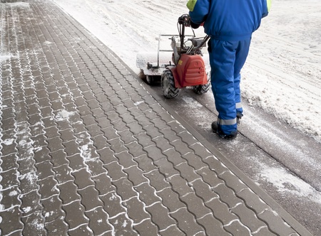 Man working with a snow blowing machineの写真素材