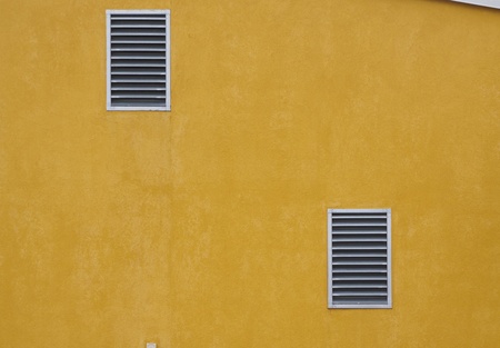 Air vent on yellow wallの写真素材