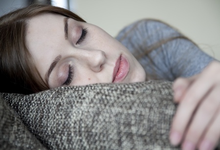 Portrait of beautiful young woman sleeping on the bedの写真素材