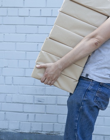 man holding a pile of package parcelsの写真素材