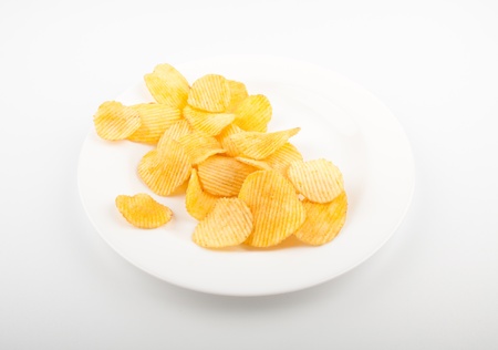 Potato chips heap on the white plate