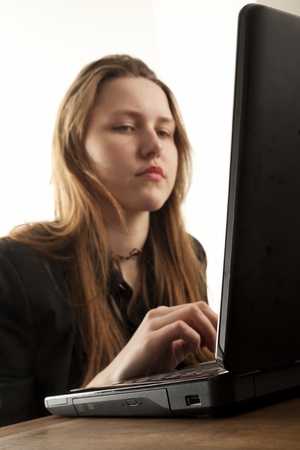 Girl using a laptop to browse the netの写真素材