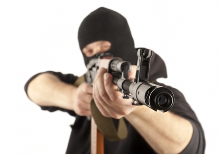 Man in mask with gun on white backgroundの写真素材