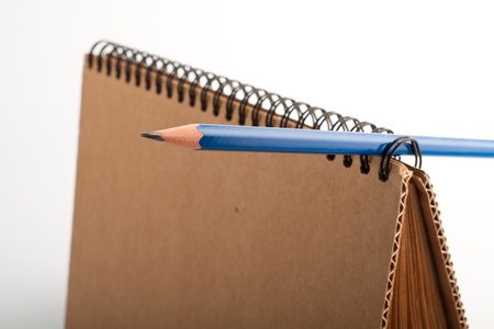 New paper notepad and blue pencil