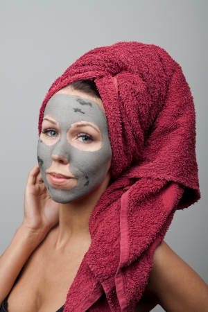 Clay facial mask. The portrait of young woman.の写真素材