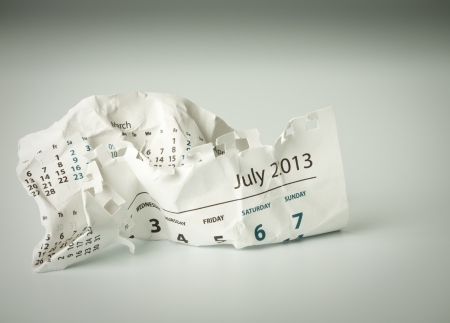 July. Calendar sheet. Crumpled paper on the floor.の写真素材