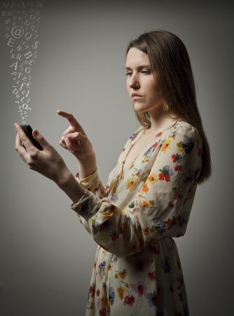 Beautiful young woman using a mobile phoneの写真素材
